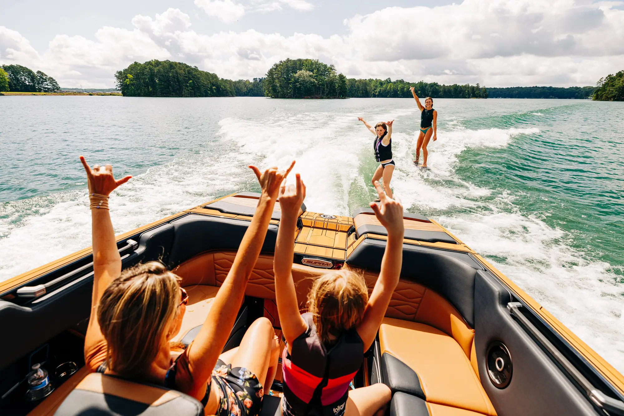 Boats and wakeboarders enjoying a day on the lake