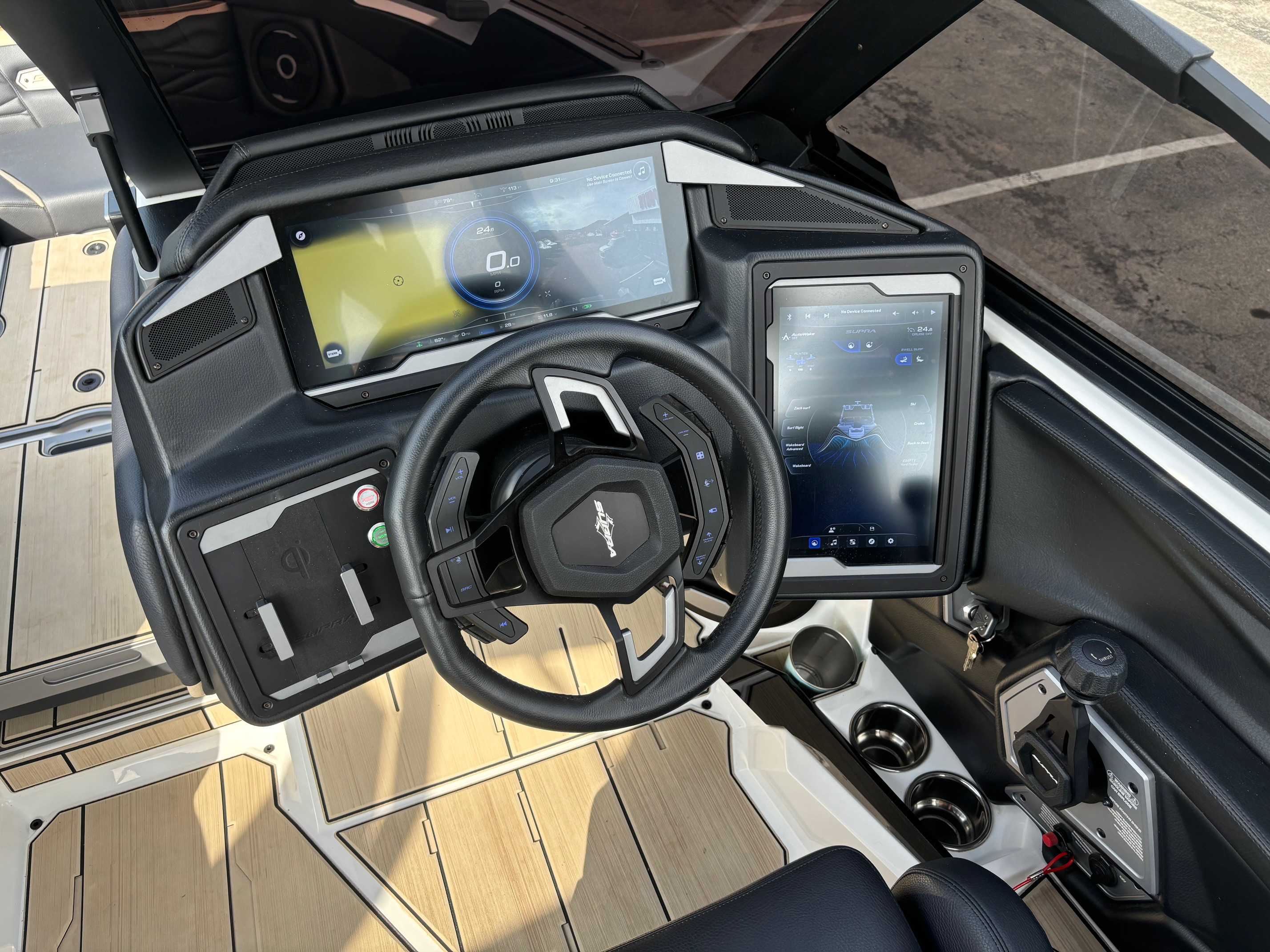 Dashboard view of a new 2026 Supra SL550 wakeboard boat, featuring digital displays and steering controls.